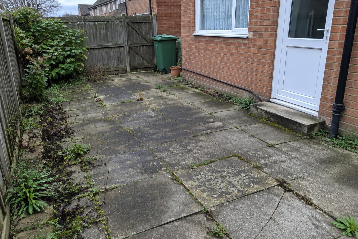 Existing patio with cracked, weathered slabs